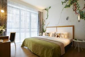 a bedroom with a bed and a large window at City Hotel Thessaloniki in Thessaloniki