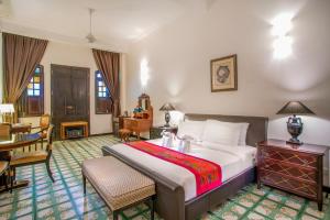 a bedroom with a bed and a table and chairs at Areca Hotel Penang in George Town