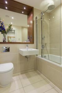 a bathroom with a toilet and a sink and a shower at Citystay - Mill Park Apartments in Cambridge