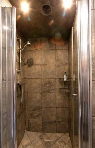 a shower with a glass door in a bathroom at City HotelApartment in Karlshamn