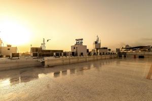 a view of a factory with the sunset in the background at Hotel Sheetal Plaza in Surat