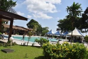 a pool at a resort with people in it at Hôtel Sawa in Douala