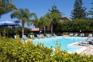basen z leżakami i palmami w obiekcie Hotel La Fattoria Sul Mare w mieście Capo Vaticano