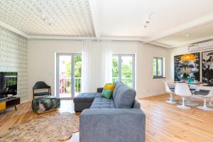 a living room with a couch and a table at Mama Coco Cascais Apartments in Cascais