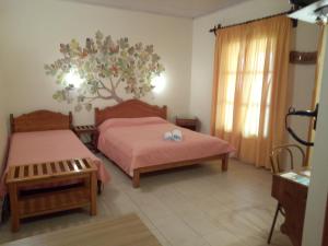 A bed or beds in a room at Pansion Matoula