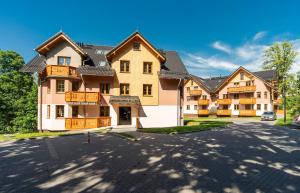 a large house with a driveway in front of it at Apartamenty Sun Seasons 24 - Nadrzeczna II Centrum in Karpacz