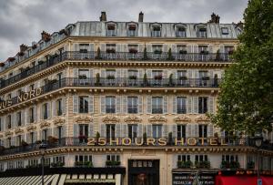 
a large building with a clock on the front of it at 25hours Hotel Terminus Nord in Paris
