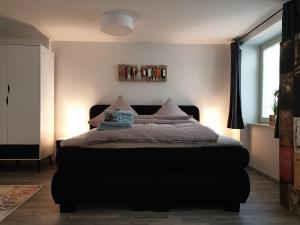 a bedroom with a bed with pillows on it at Studioapartment L46 - in exklusiver Innenstadtlage in Potsdam