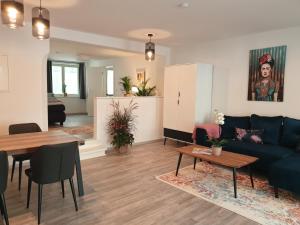 a living room with a blue couch and a table at Studioapartment L46 - in exklusiver Innenstadtlage in Potsdam