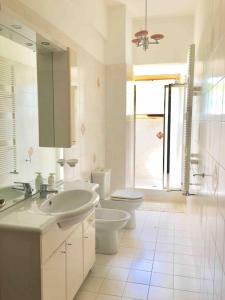 a bathroom with a sink and a toilet and a mirror at La Terrazza di Filomena - Picinisco, Parco Lazio & Abruzzo in Picinisco
