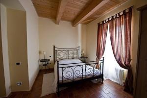 a bedroom with a bed and a large window at Antica Loggia in Fabriano