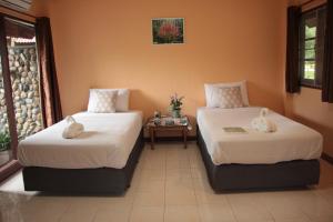 A bed or beds in a room at River Kwai Park & Resort