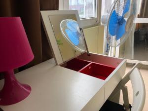 a desk with a fan and a red lamp at Jivko's Studio in Varna City