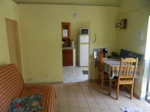 a kitchen and dining room with a table and chairs at Maison de la plage in Trois-Rivières
