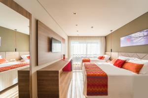 Postel nebo postele na pokoji v ubytování Hotel Laghetto Stilo Borges