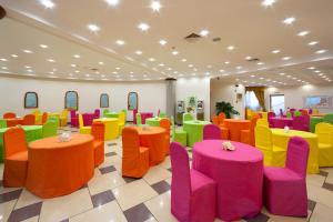 a room with brightly colored tables and chairs at Ulisse Deluxe Hostel in Sorrento