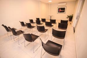 a conference room with black chairs and a table at Alfa Hotel Teresina in Teresina