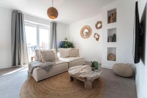 a living room with a couch and a coffee table at Bamboa Beachhouse in Zandvoort