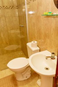 a bathroom with a toilet and a sink and a shower at Pousada Porto Azul in Cumbuco +22 photos