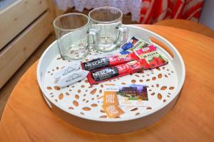 a table with a white plate withocolates and a glass at Pod Gorcami in Waksmund