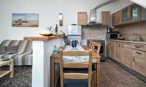 a kitchen with a table and a couch in a room at The Junction Appartment in Agia Galini