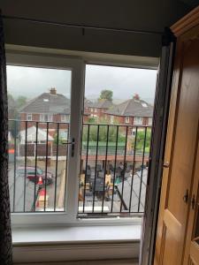 a window with a view of a parking lot at Lake Lounge Rooms in Littleborough +9 photos