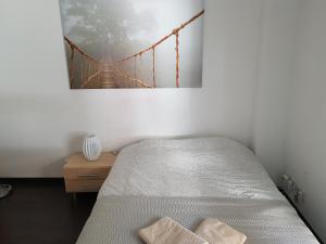 um quarto com uma cama e uma pintura de ponte na parede em Charmant 3P proche centre ville em Estrasburgo