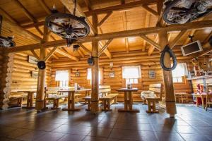 a large room with wooden walls and tables and clocks at Ranč pod Ostrou Skalou in Stratená