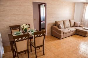 a living room with a table and a couch at APARTAMENT SARDINA NEAR THE BEACH WITH POOL AND WIFI e in Gáldar