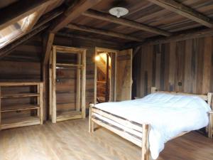 a bedroom with a bed and a wooden ceiling at gîte 8 personnes " LE CHAMOIS " in Gerbépal