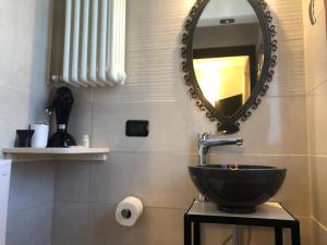 a bathroom with a sink and a mirror at La Casa di Anna in Delebio