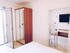 a bedroom with a mirror and a bed and a desk at Villa Dubravka in Lopar