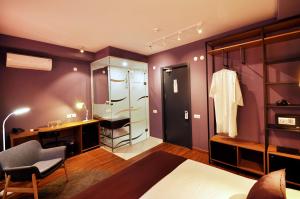 a bedroom with purple walls and a dressing room at Elle Boutique Hotel in Tbilisi City