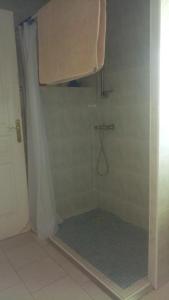 a bathroom with a shower with a shower curtain at GITE PROVENCE LUBERON -PACA- Acces PMR-ANCV in Revest-des-Brousses