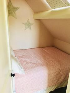 Habitación pequeña con cama con estrellas en la pared en White Horse & Griffin en Whitby