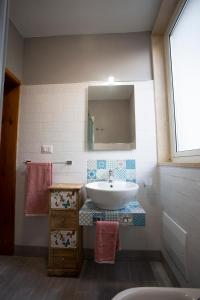 a bathroom with a sink and a mirror at 4sisters' Open Space in Aradeo +73 photos