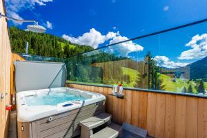 eine Whirlpool-Badewanne mit Bergblick in der Unterkunft Hotel Rosengarten in Toblach