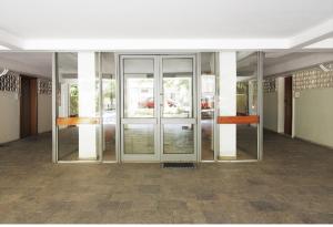 a large glass door in an empty building at Christina's flat in Athens