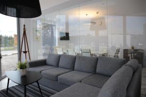 a living room with a couch and a table at Hotell Norrort in Vallentuna