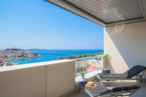 a balcony with chairs and a view of the ocean at Apartments Zorka in Primošten