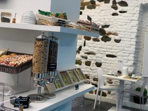 a store with a shelf of food on a wall at Adalesia Hotel & Coffee in Turin