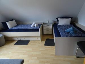 a bedroom with two beds and a night stand at Helle Ferienwohnung in Nettetal bei Venlo in Nettetal