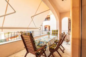 a dining room with a table and chairs on a balcony at Casa Vacanze Pedras in Santa Maria Navarrese