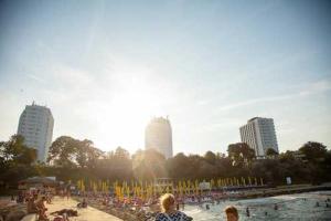 a group of people on a beach near a body of water at Complex Hotelier Steaua de Mare - Hotel Delfinul in Eforie Nord