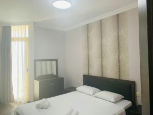 A bed or beds in a room at Orbi Plaza Black Sea