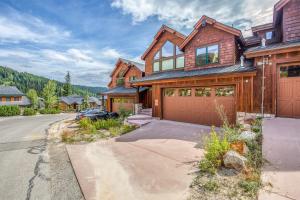 a wooden house with a garage and a driveway at Northwest Passage Retreat in Sandpoint