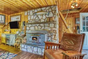 a living room with a stone fireplace at Whispering Pines in Leavenworth