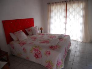 Schlafzimmer mit einem großen Bett mit einem roten Kopfteil in der Unterkunft Art Hotel Cristal de Igatu in Igatu