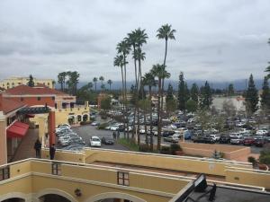 a view of a parking lot with palm trees and cars at Valley Hotel in Rosemead