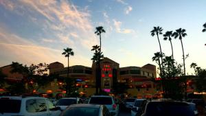 a parking lot with cars parked in front of a building at Valley Hotel in Rosemead